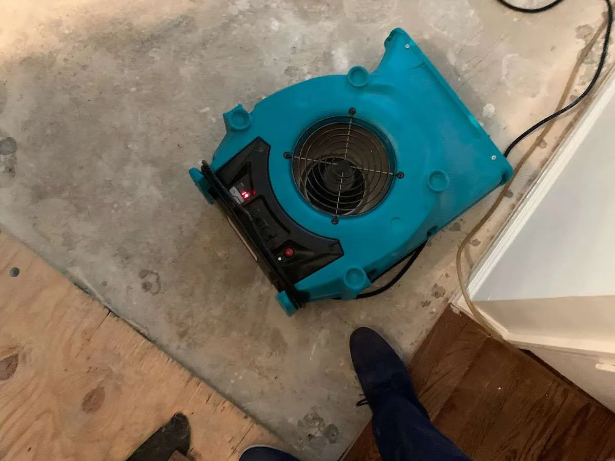 Air mover drying subfloor during Leak Detection & Repair in Kearney